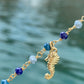 Bracciale marinaro in argento giallo, pietre multicolors semipreziose e tre ciondoli : conchiglia, cavalluccio marino e stella marina